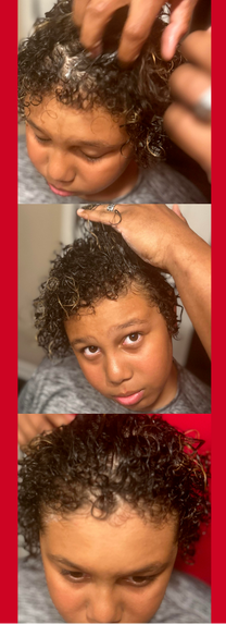 Barber Aaron Brown treats his son Kam's curly hair