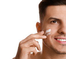 man putting on facial cream